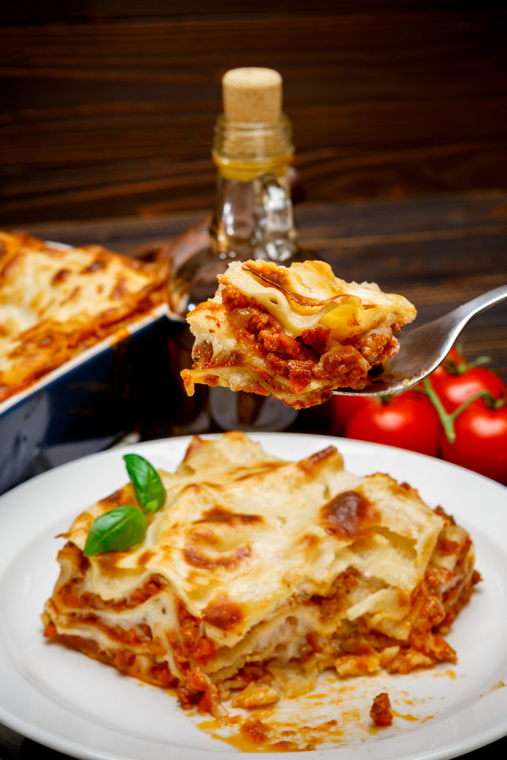 Portion of traditional tasty lasagna closeup on wooden backgound